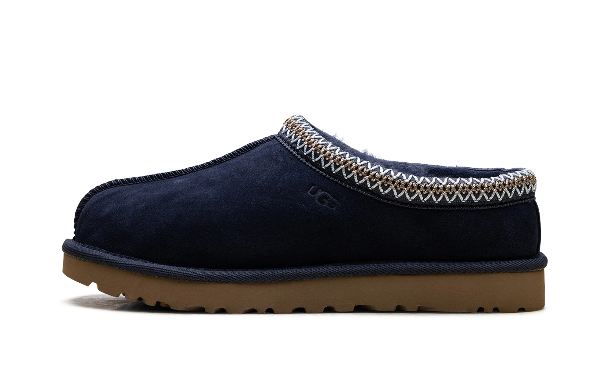 Détail du côté intérieur de la pantoufle UGG Tasman II Slipper Dark Indigo noir et bleu.